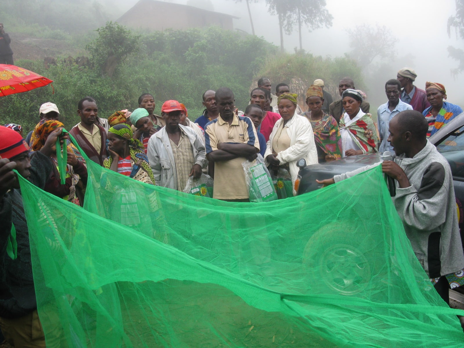 Teaching a community about mosquito nets.